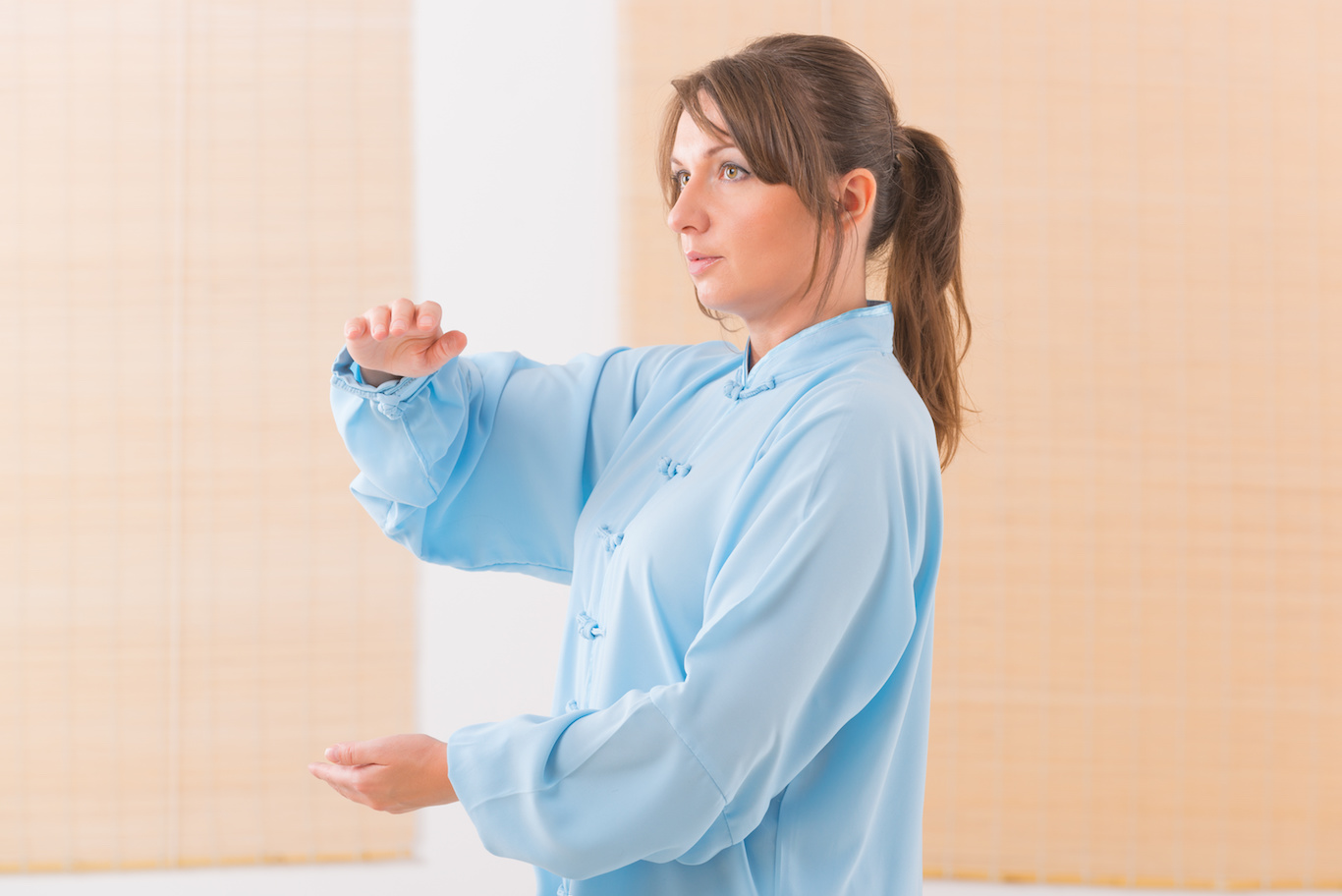 Woman doing qi gong tai chi exercise